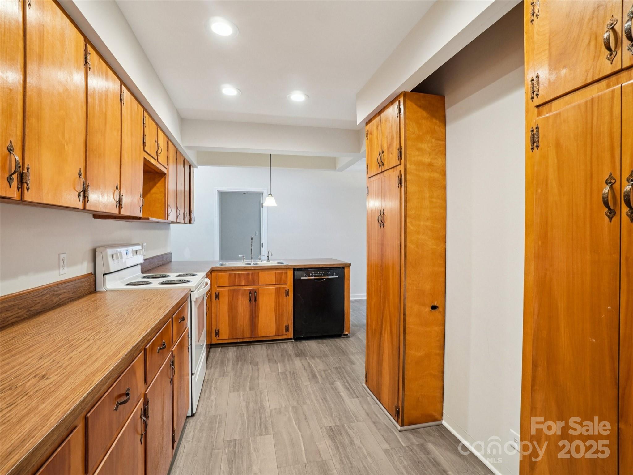 34 Parkview Drive Brevard, NC 28712 - Photo 9 of 38 a kitchen with a refrigerator a sink and wooden cabinets