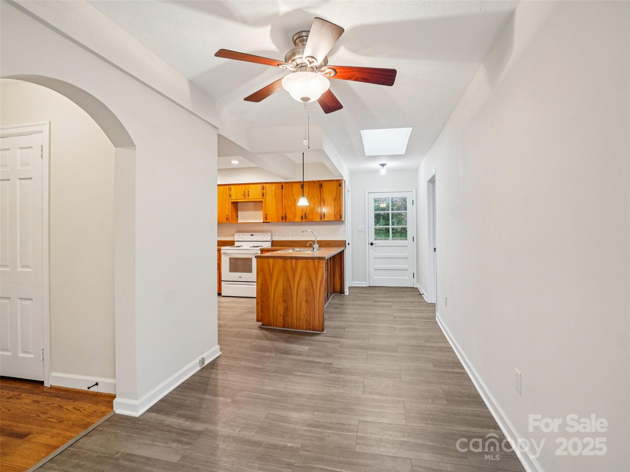 34 Parkview Drive Brevard, NC 28712 - Photo 10 of 38 a view of a kitchen with wooden floor a sink a refrigerator and window