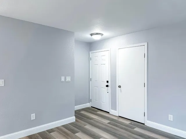 a kitchen with granite countertop a stove a sink and a microwave