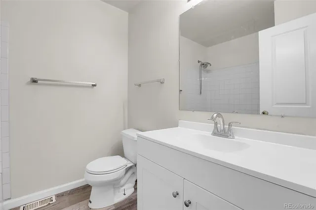 a bathroom with a sink a toilet and vanity