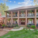 front view of a brick house with a yard