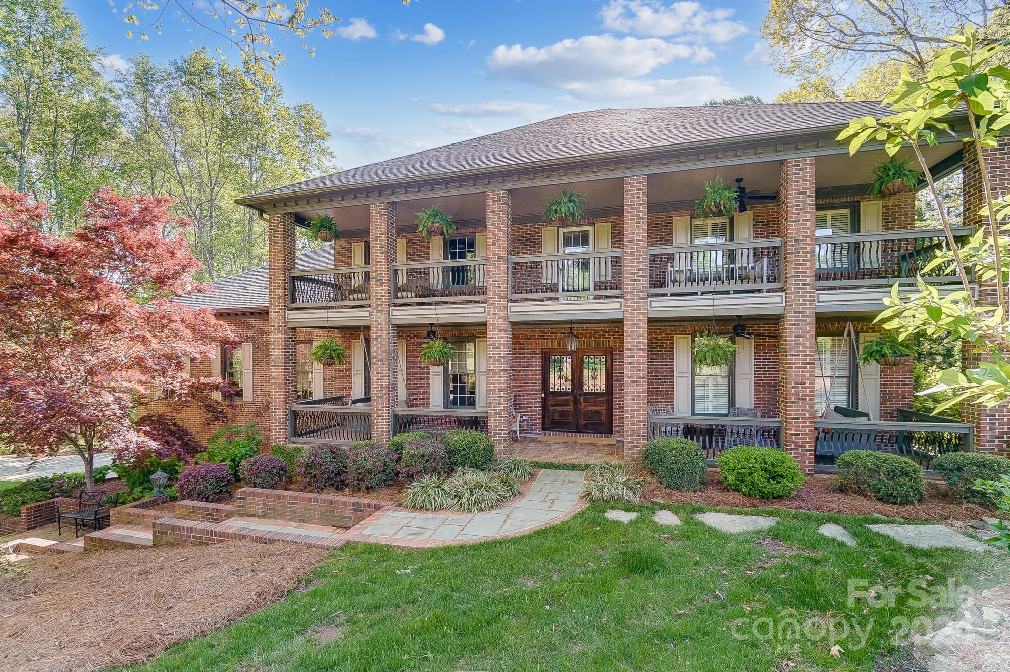 front view of a brick house with a yard