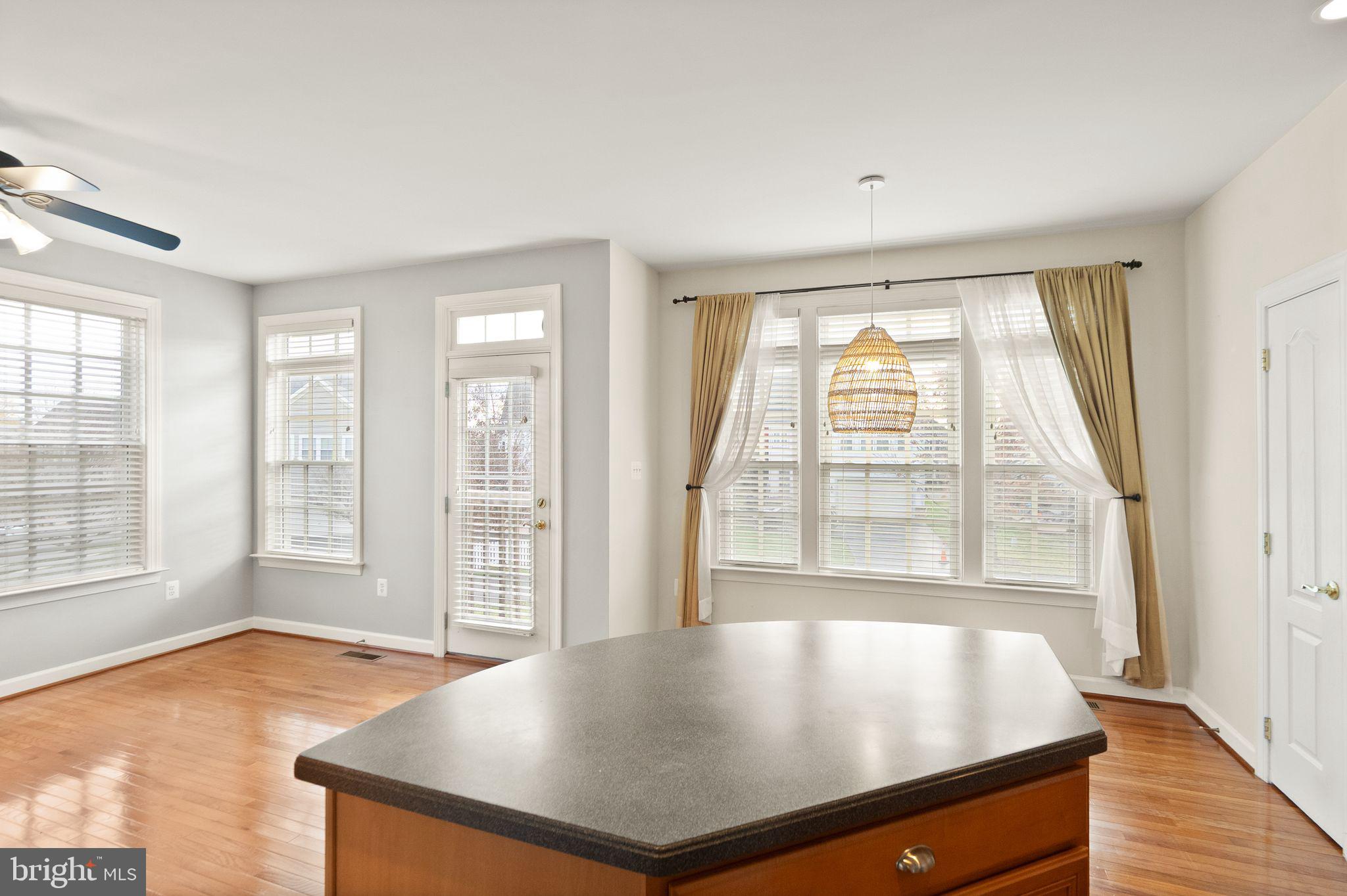 11821 Whitworth Cannon Lane Bristow, VA 20136 - Photo 31 of 70 an empty room with wooden floor and windows