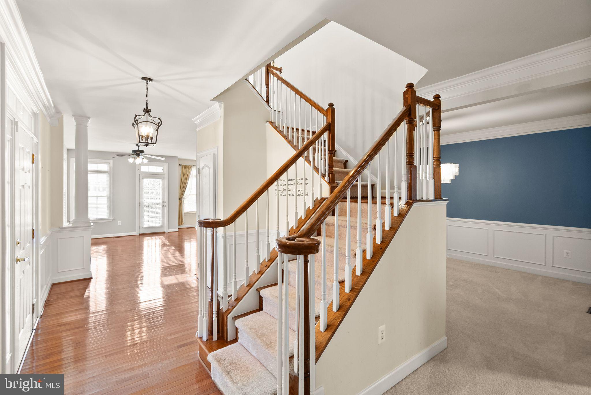 11821 Whitworth Cannon Lane Bristow, VA 20136 - Photo 34 of 70 a view of staircase with lots of frames and wooden floor