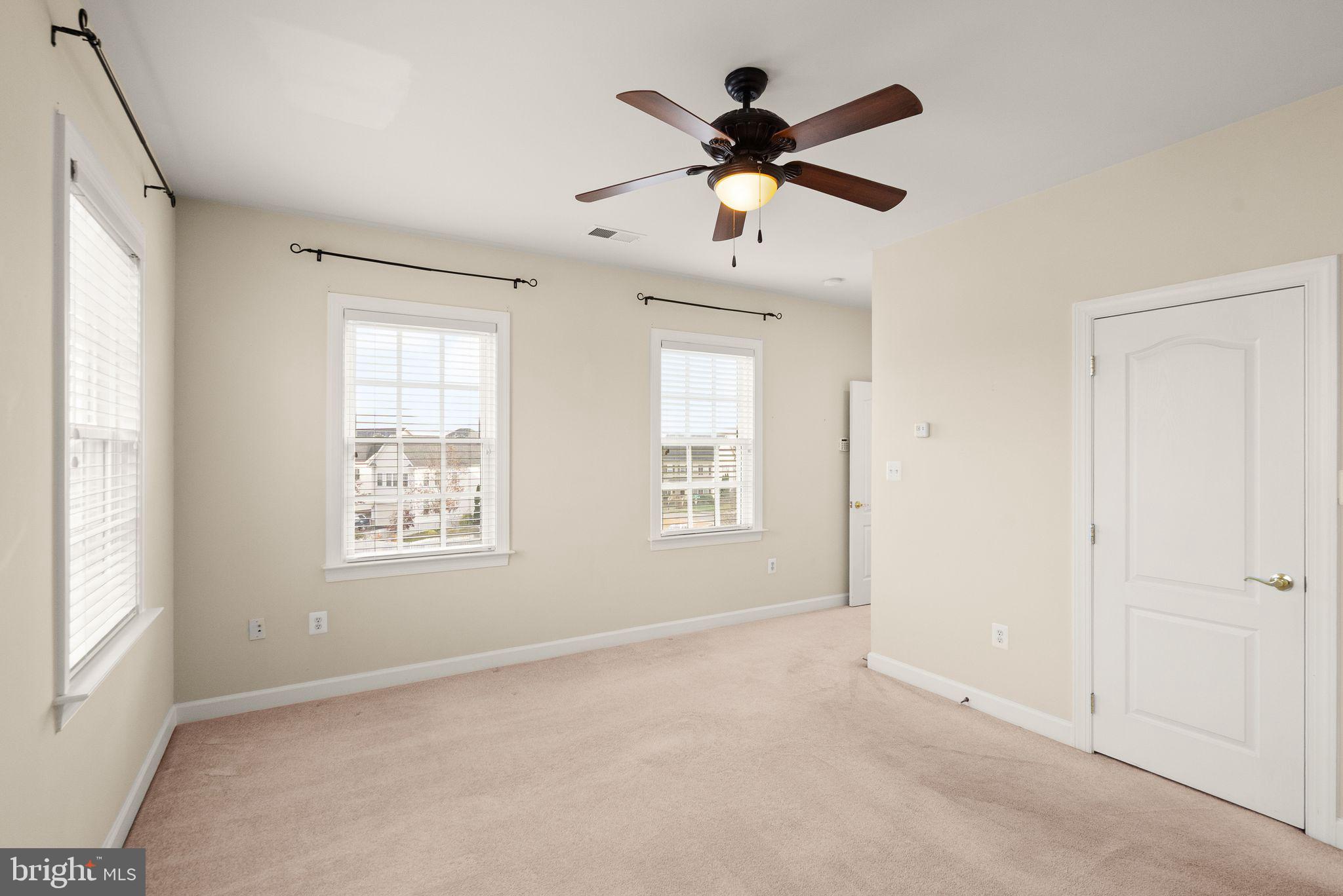 11821 Whitworth Cannon Lane Bristow, VA 20136 - Photo 41 of 70 a view of a livingroom with a ceiling fan and window