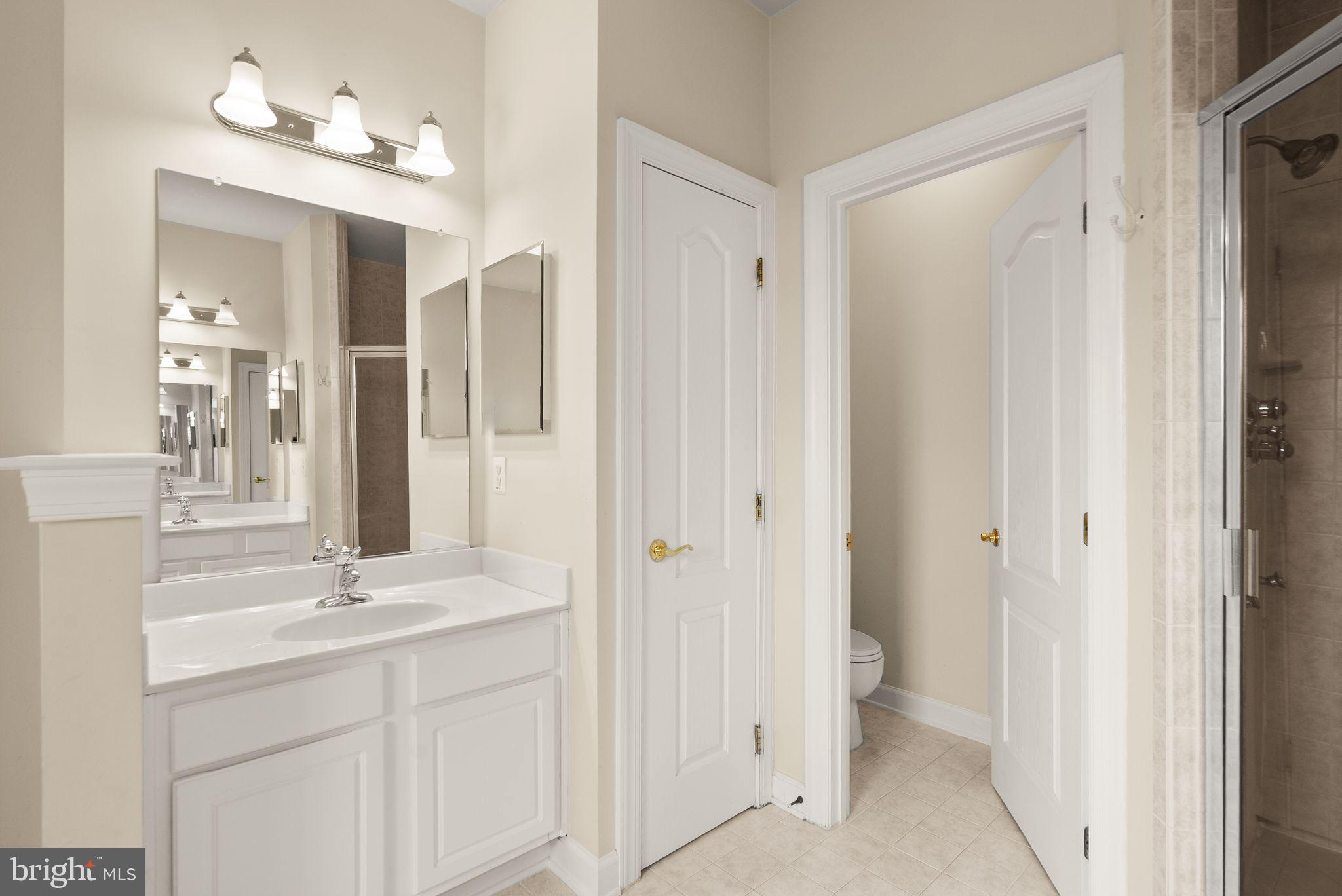 11821 Whitworth Cannon Lane Bristow, VA 20136 - Photo 45 of 70 a bathroom with a double vanity sink and mirror
