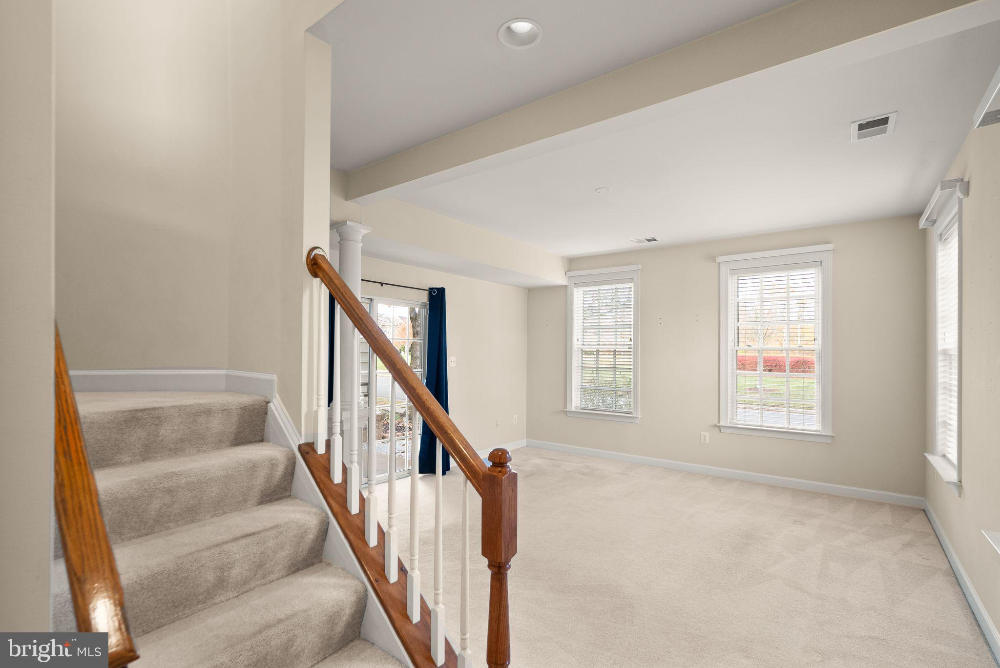 11821 Whitworth Cannon Lane Bristow, VA 20136 - Photo 56 of 70 a view of an empty room with wooden floor and stairs