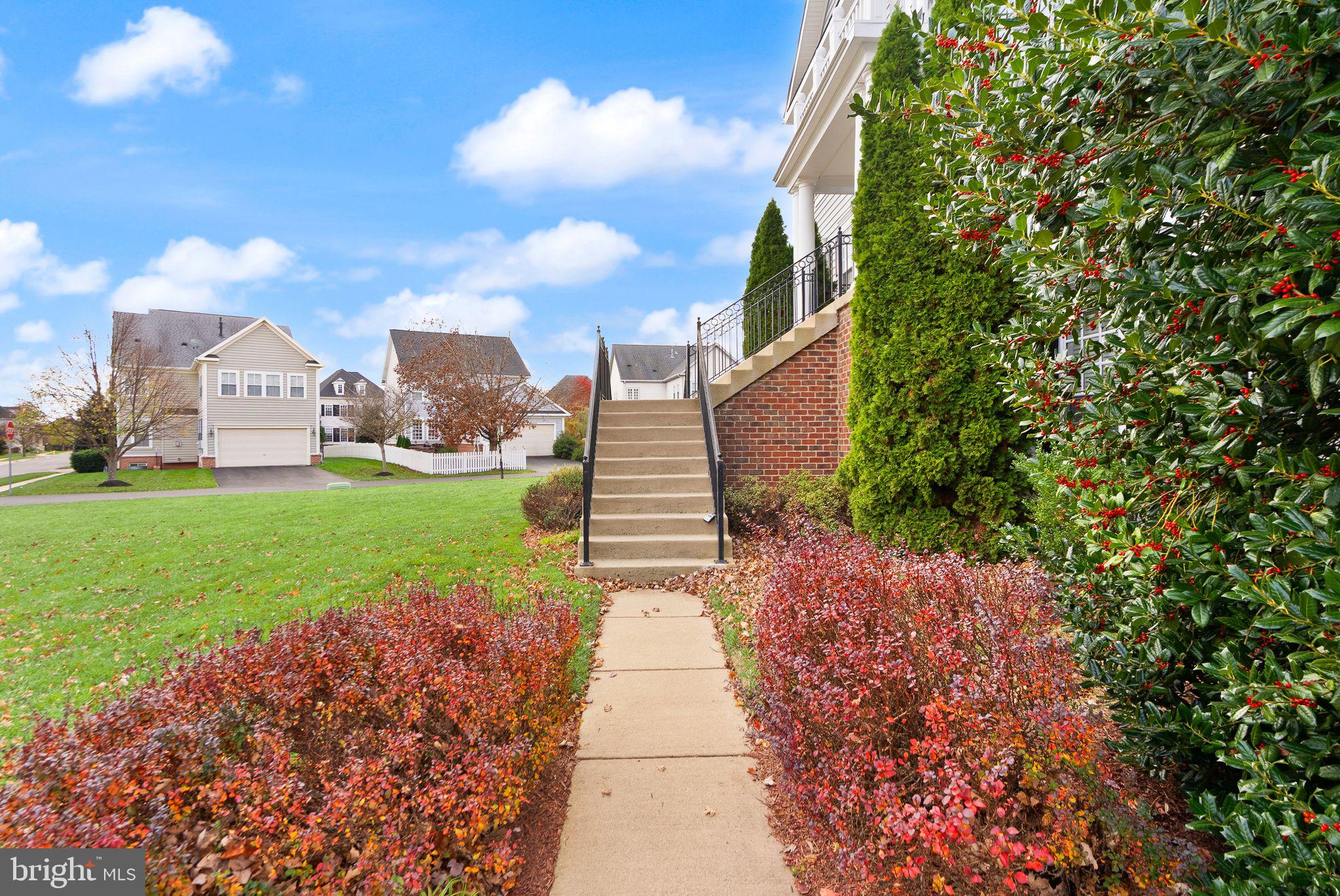 11821 Whitworth Cannon Lane Bristow, VA 20136 - Photo 6 of 70 a pathway of a house with a yard