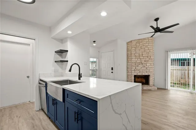 a view of a room with wooden floor and ceiling fan