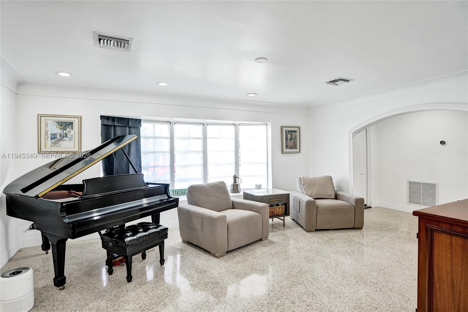 280 Northeast Spanish Court, Unit 280 Boca Raton, FL 33432 - Photo 15 of 41 a living room with furniture and a piano