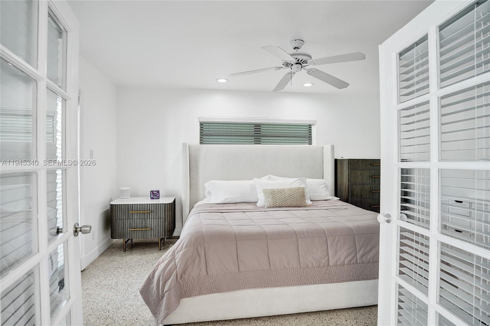 280 Northeast Spanish Court, Unit 280 Boca Raton, FL 33432 - Photo 16 of 41 a bedroom with a bed and a ceiling fan