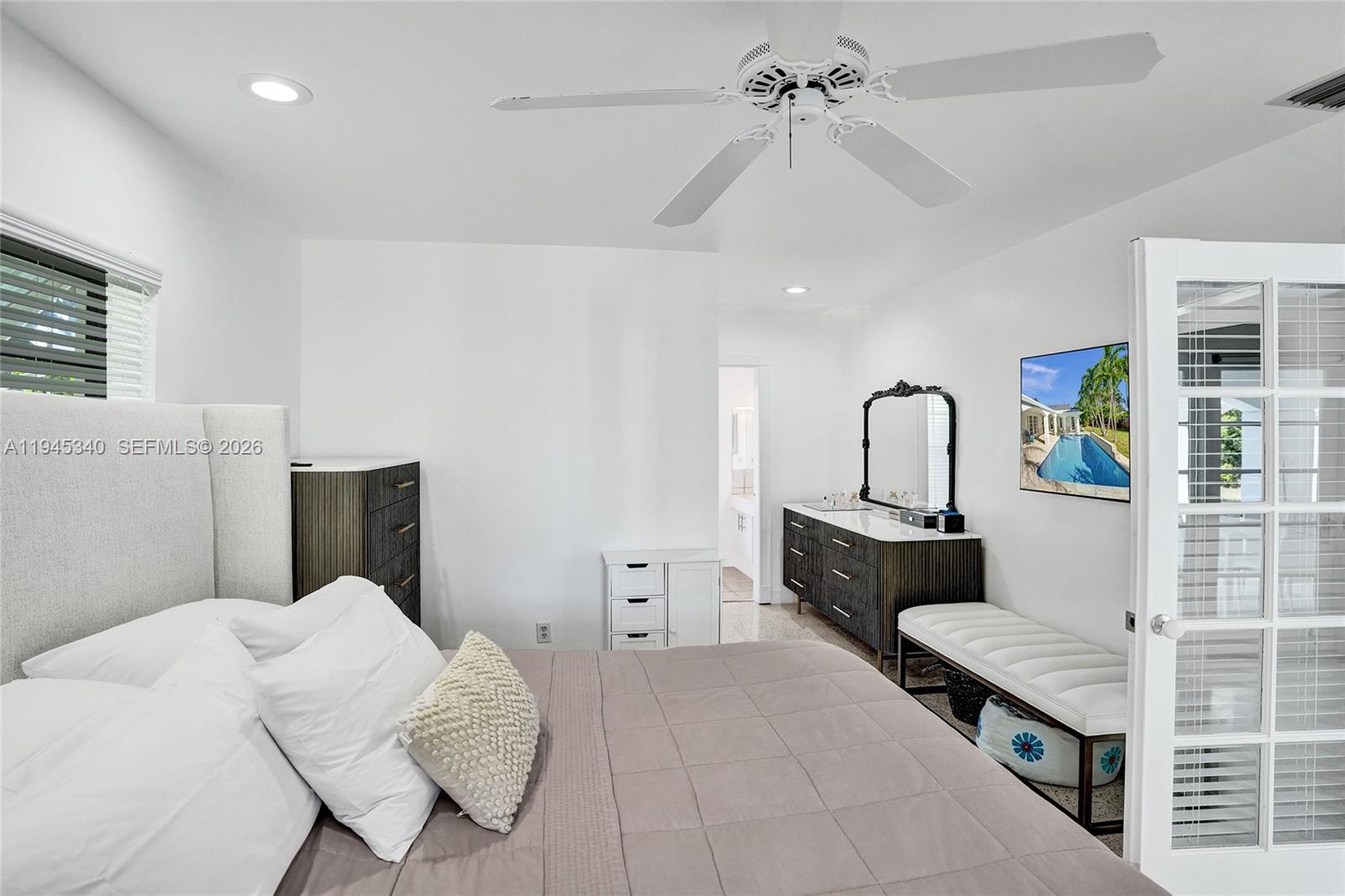 280 Northeast Spanish Court, Unit 280 Boca Raton, FL 33432 - Photo 18 of 41 a bedroom with a bed and ceiling fan