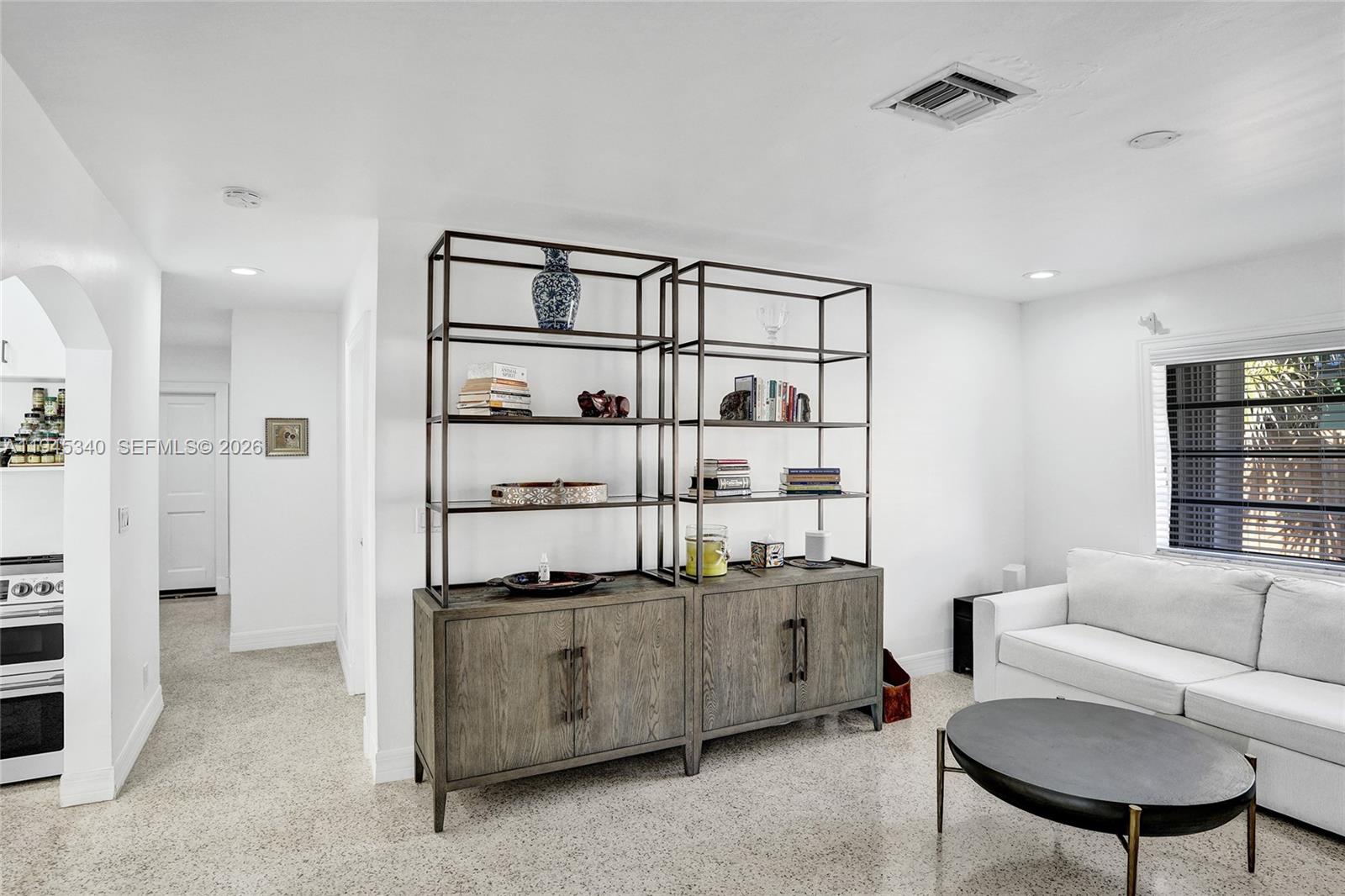 280 Northeast Spanish Court, Unit 280 Boca Raton, FL 33432 - Photo 25 of 41 a living room with stainless steel appliances kitchen island a table and chairs