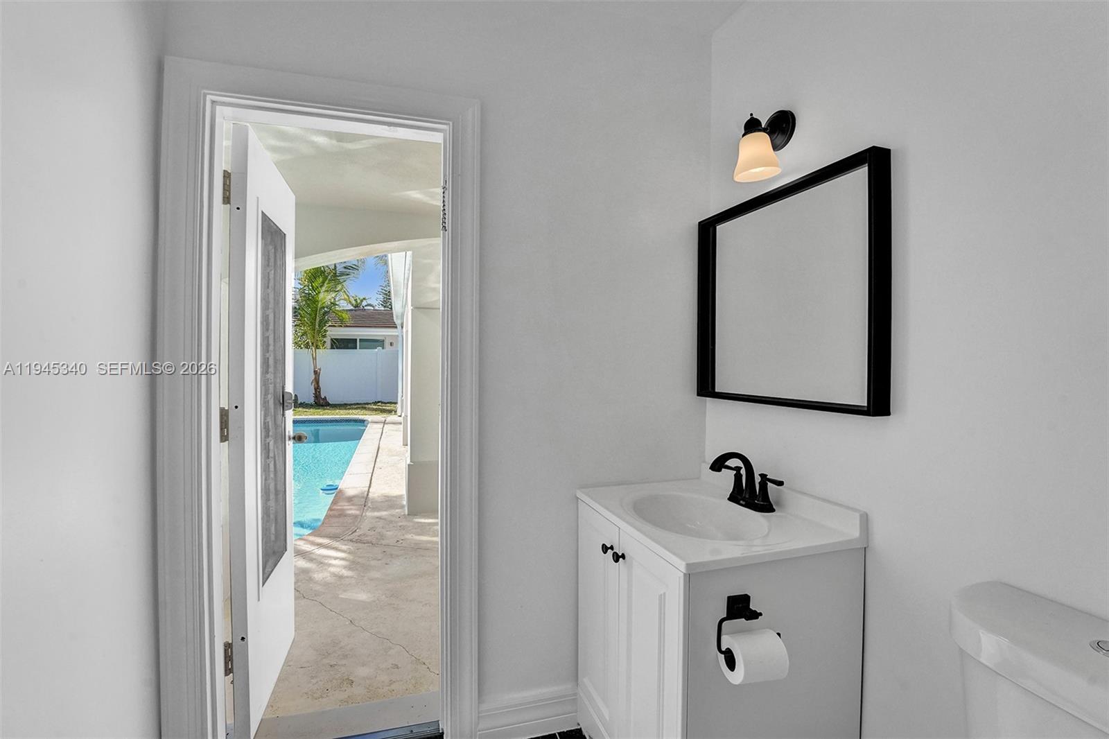 280 Northeast Spanish Court, Unit 280 Boca Raton, FL 33432 - Photo 28 of 41 a view of bathroom with a sink and mirror