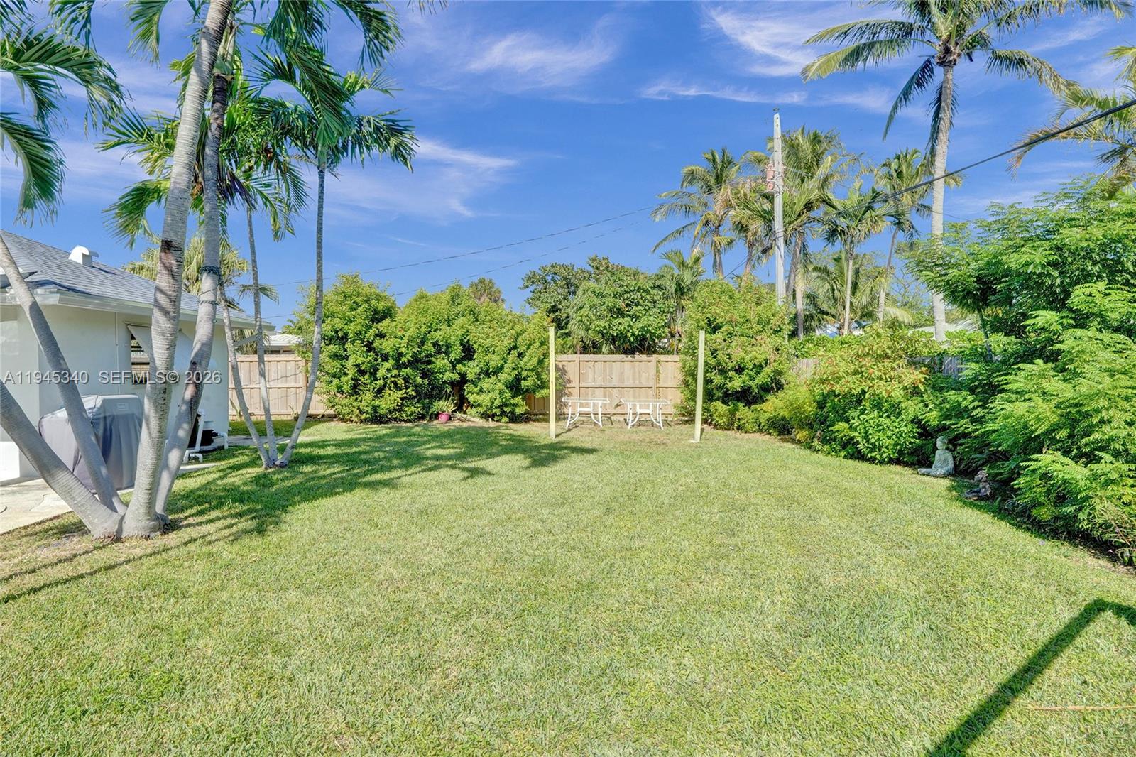 280 Northeast Spanish Court, Unit 280 Boca Raton, FL 33432 - Photo 36 of 41 a view of a yard with plants and tree