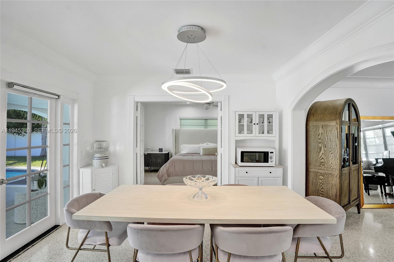 280 Northeast Spanish Court, Unit 280 Boca Raton, FL 33432 - Photo 10 of 41 a view of a dining room with furniture and wooden floor