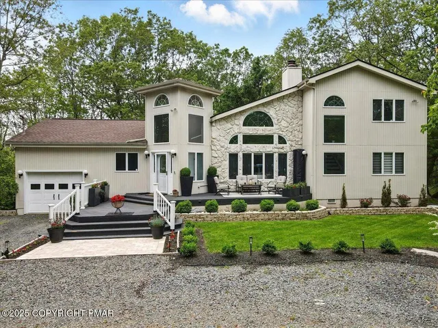 a living room with furniture a fireplace and a chandelier