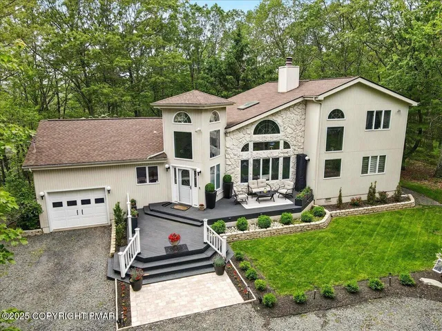 a living room with furniture dining area and a chandelier