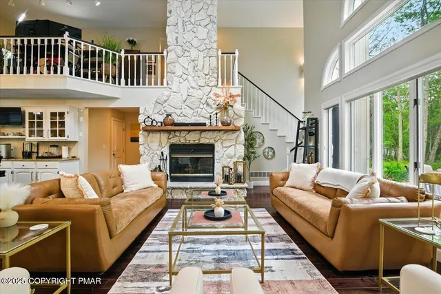 a living room with furniture a fireplace and a wall painting