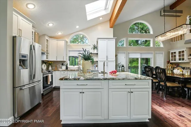 a white bath tub sitting in a bathroom next to a window