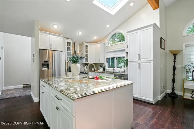 a bathroom with a window and a shower