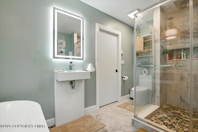 a view of a patio with table and chairs with wooden floor and fence