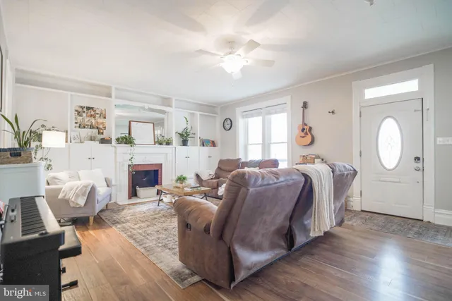 a living room with furniture and wooden floor