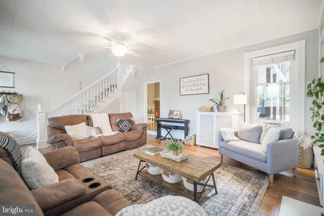 a living room with furniture fireplace and a large window