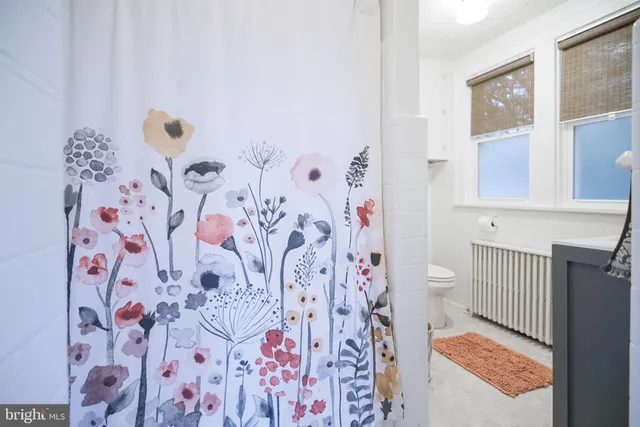 a white toilet sitting next to a bathroom sink