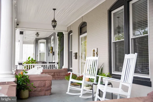 a bedroom with furniture and a large window