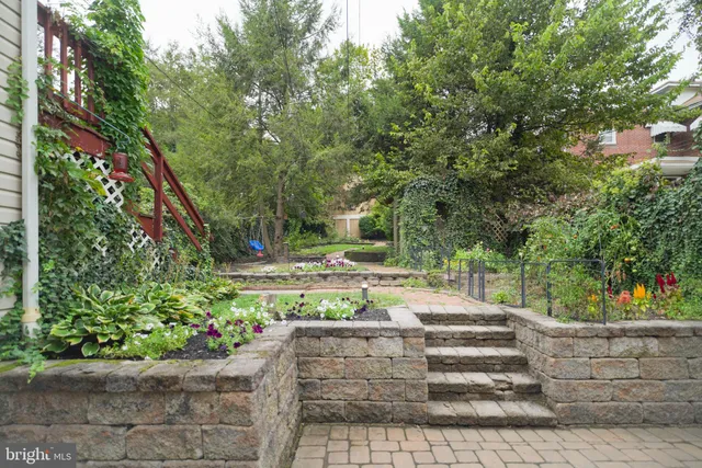 a view of a patio with table and chairs and potted plants