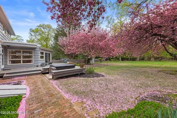 a front view of a house with a yard and trees