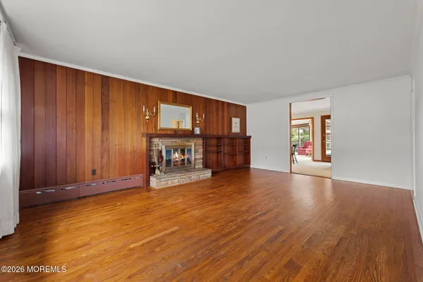 a view of a livingroom with furniture wooden floor and window