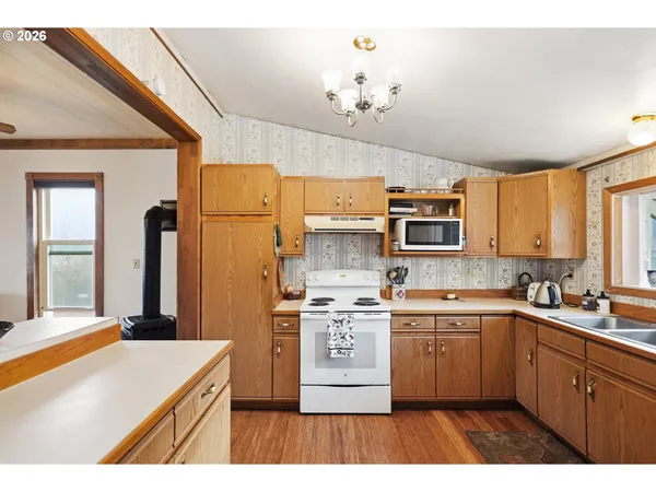 a kitchen with a sink stove and refrigerator