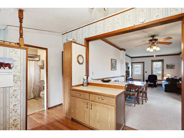 a dining hall with stainless steel appliances granite countertop a refrigerator and dining table