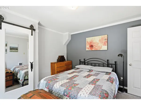 a bedroom with two beds and a chandelier