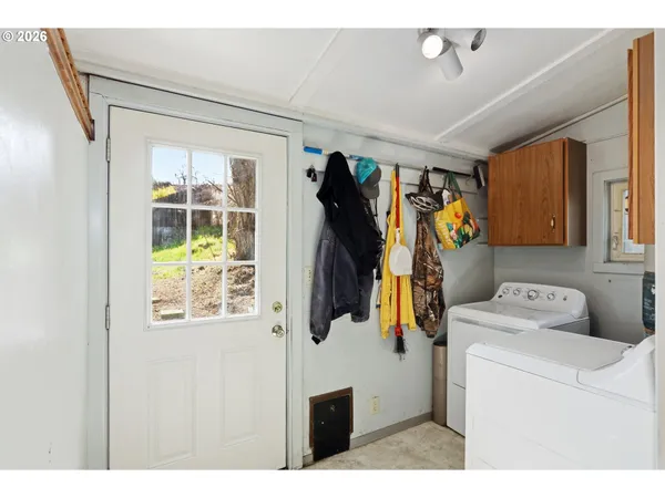 a utility room with closet dryer and washer