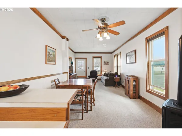 a view of a livingroom with furniture and a ceiling fan