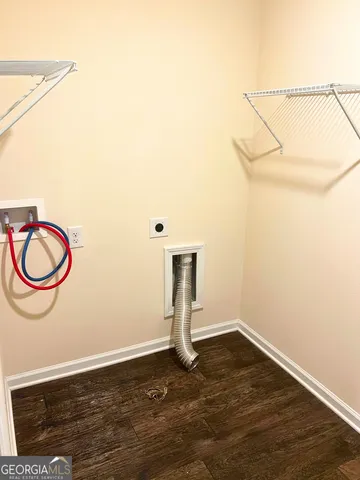 a close view of a refrigerator in kitchen with stainless steel appliances wooden floor