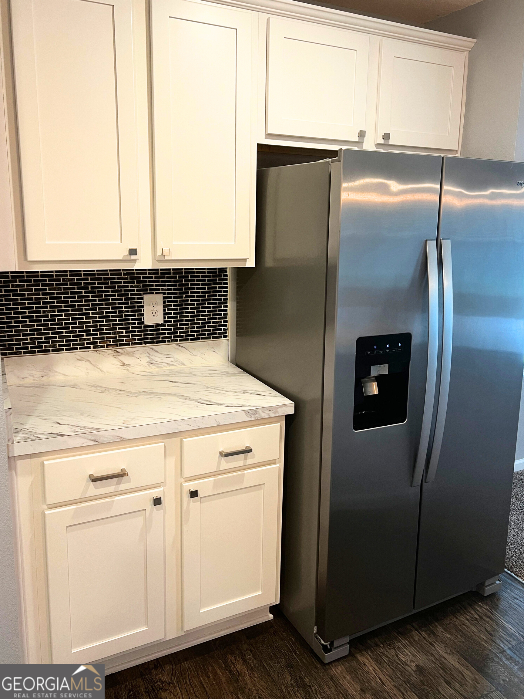 129 Holston Circle Kingsland, GA 31548 - Photo 14 of 25 a close view of a refrigerator in kitchen with stainless steel appliances wooden floor