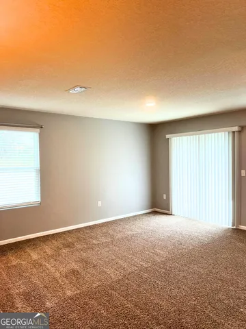 an empty room with a wooden floor and a window
