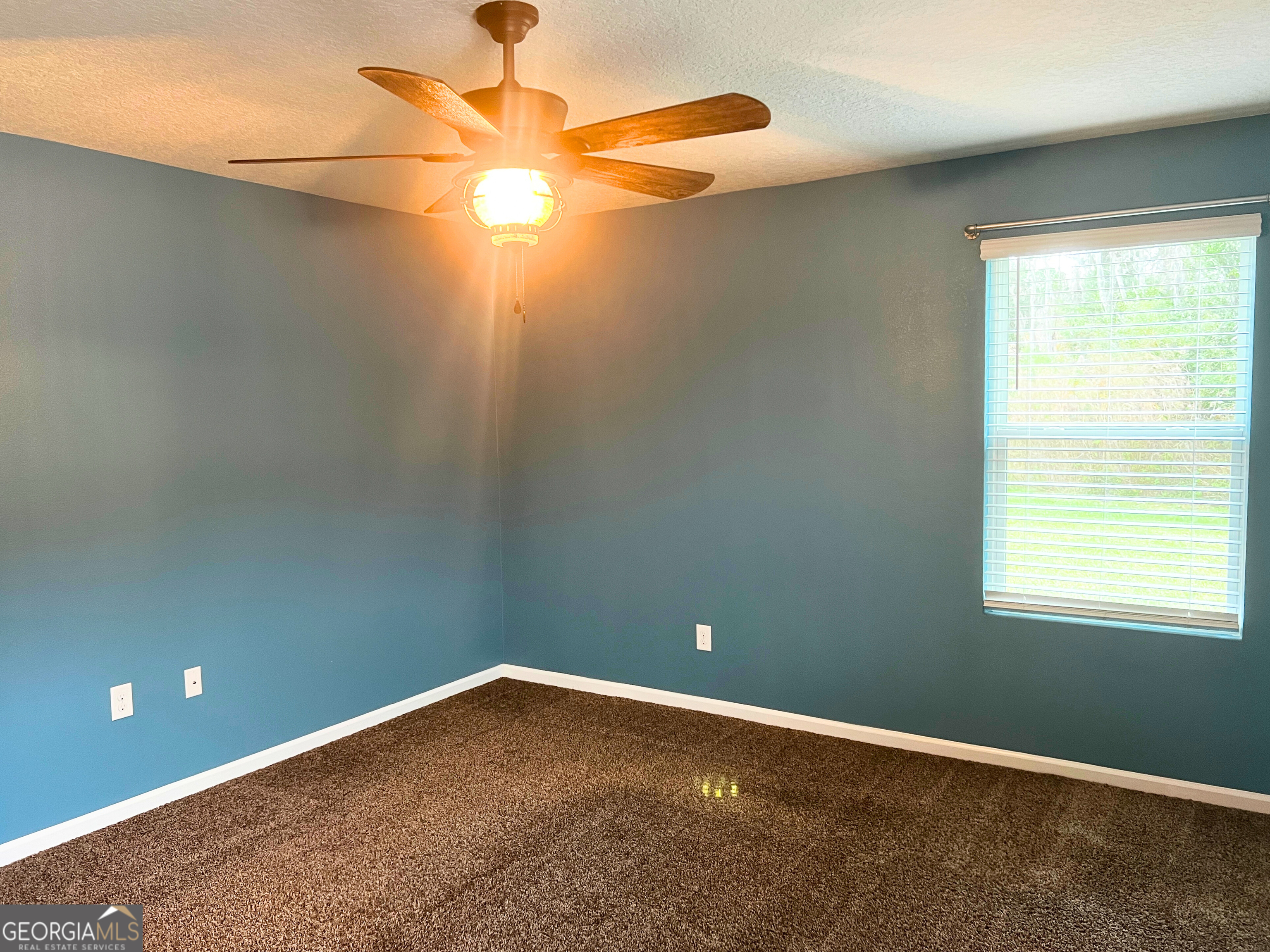 129 Holston Circle Kingsland, GA 31548 - Photo 21 of 25 an empty room with a fan and a window