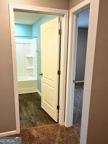 a bathroom with a shower and a sink