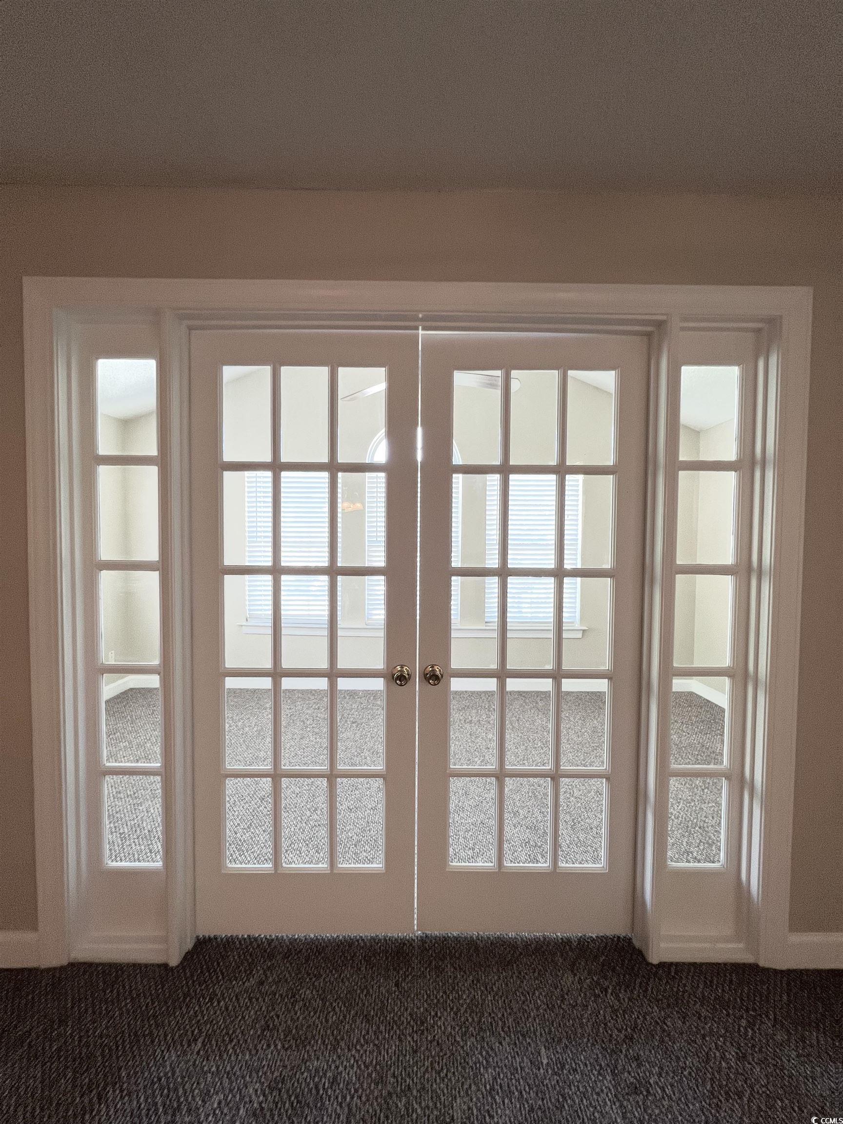 4394 Daphne Lane, Unit F Murrells Inlet, SC 29576 - Photo 11 of 40 Doorway to outside with french doors and dark colored carpet
