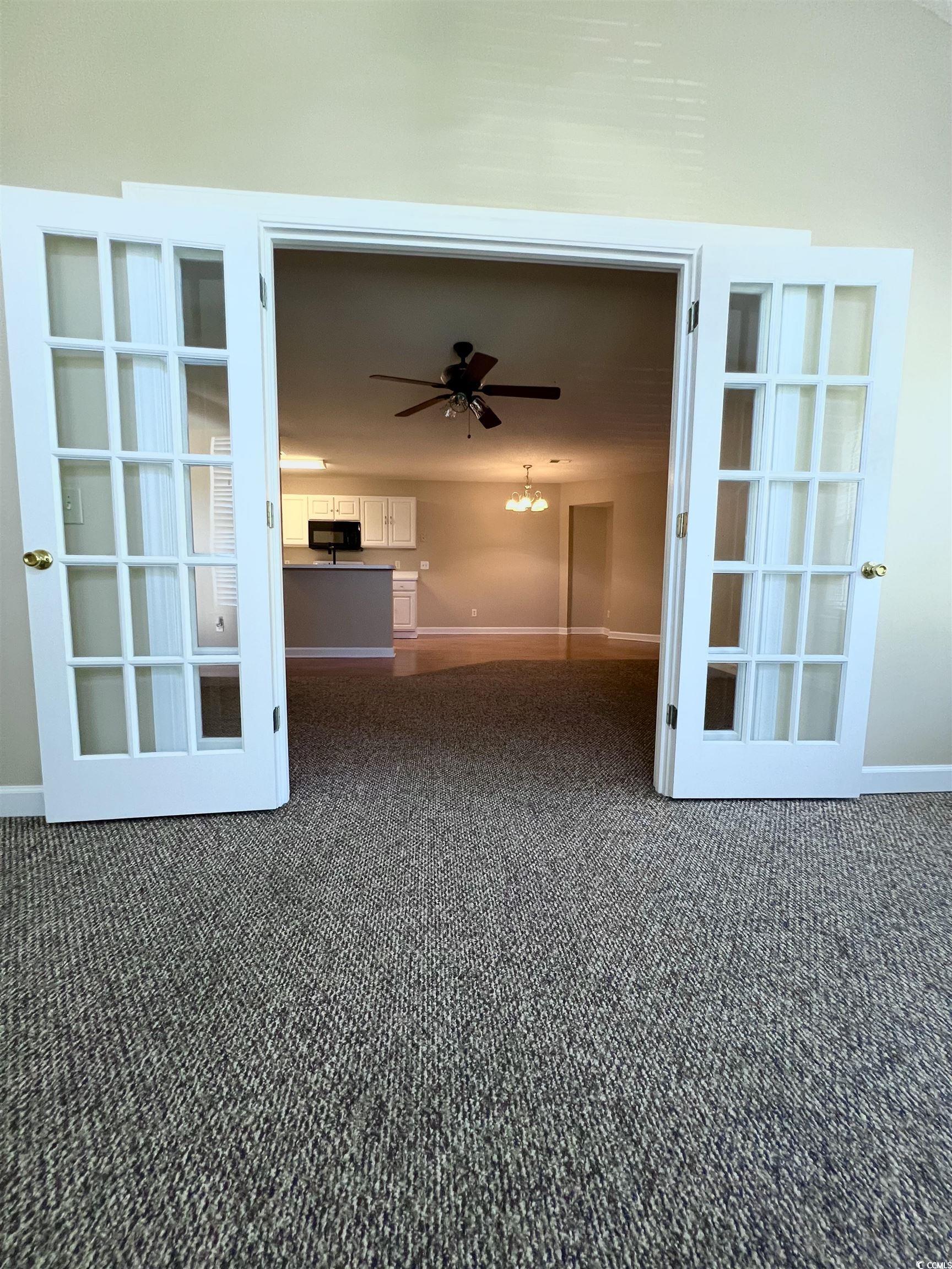 4394 Daphne Lane, Unit F Murrells Inlet, SC 29576 - Photo 13 of 40 Unfurnished room with dark carpet, a ceiling fan, french doors, and baseboards