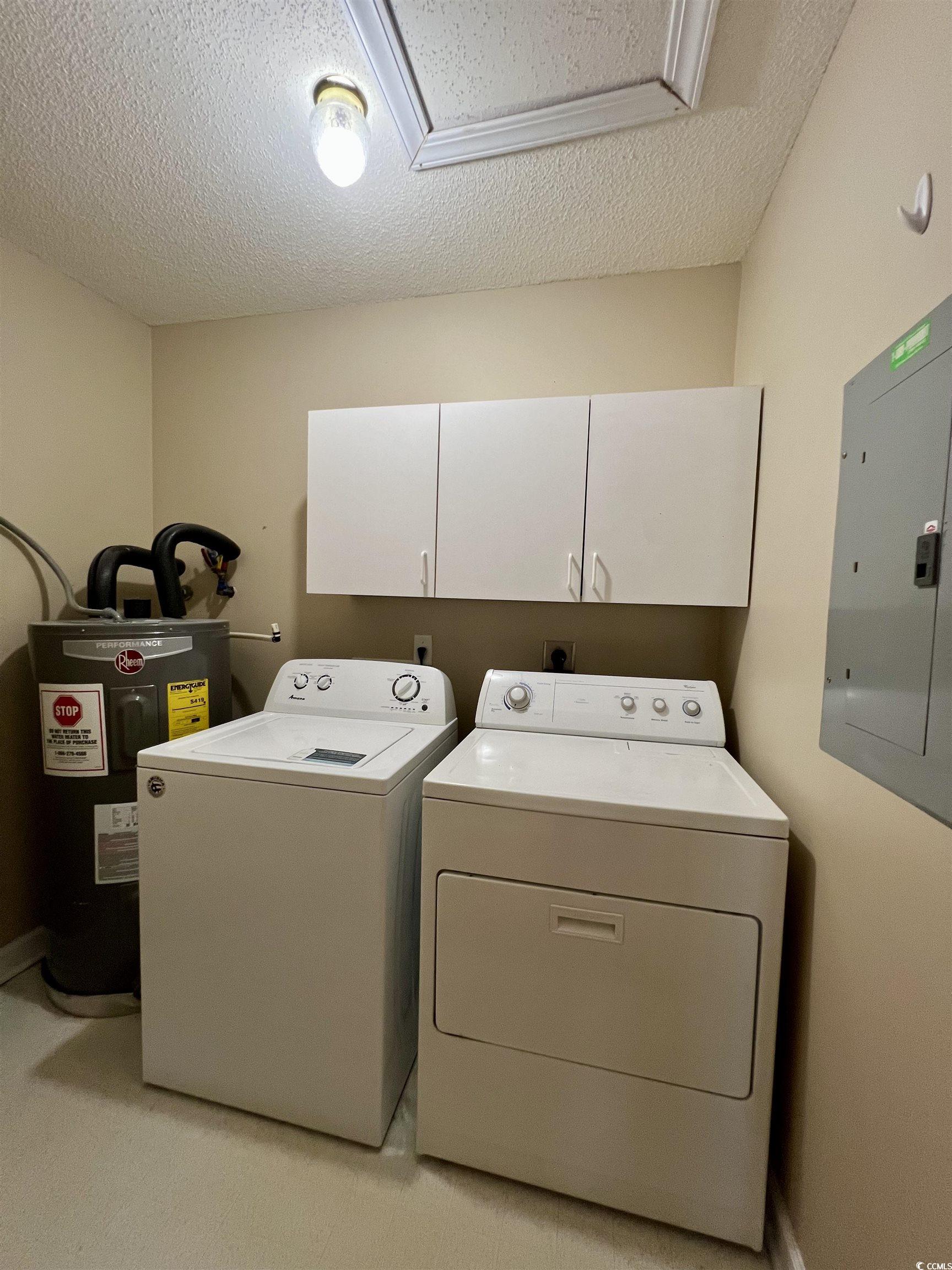 4394 Daphne Lane, Unit F Murrells Inlet, SC 29576 - Photo 14 of 40 Clothes washing area featuring washing machine and clothes dryer, electric water heater, cabinet space, electric panel, and a textured ceiling
