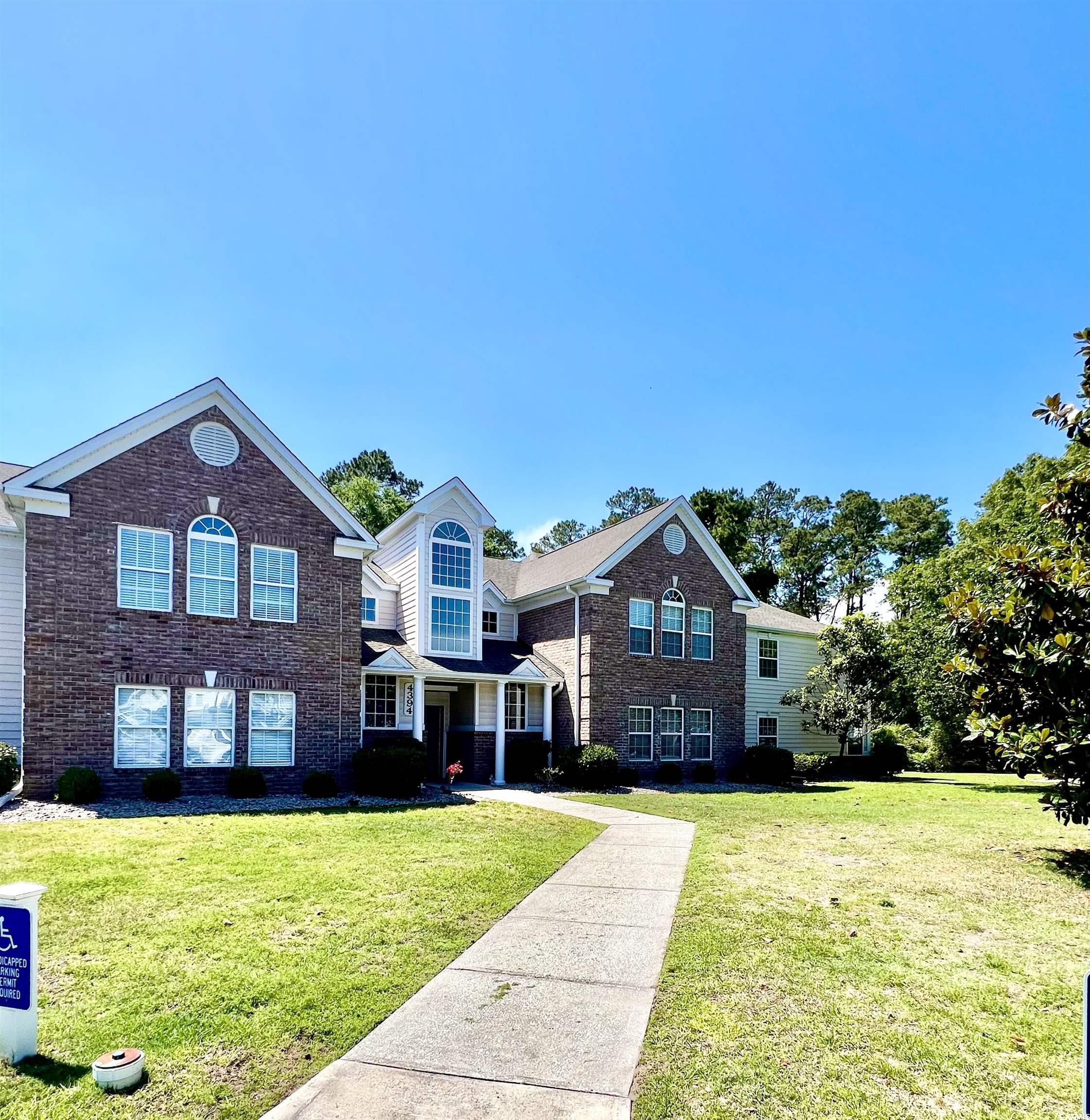 4394 Daphne Lane, Unit F Murrells Inlet, SC 29576 - Photo 2 of 40 Traditional-style home with a front yard and brick siding