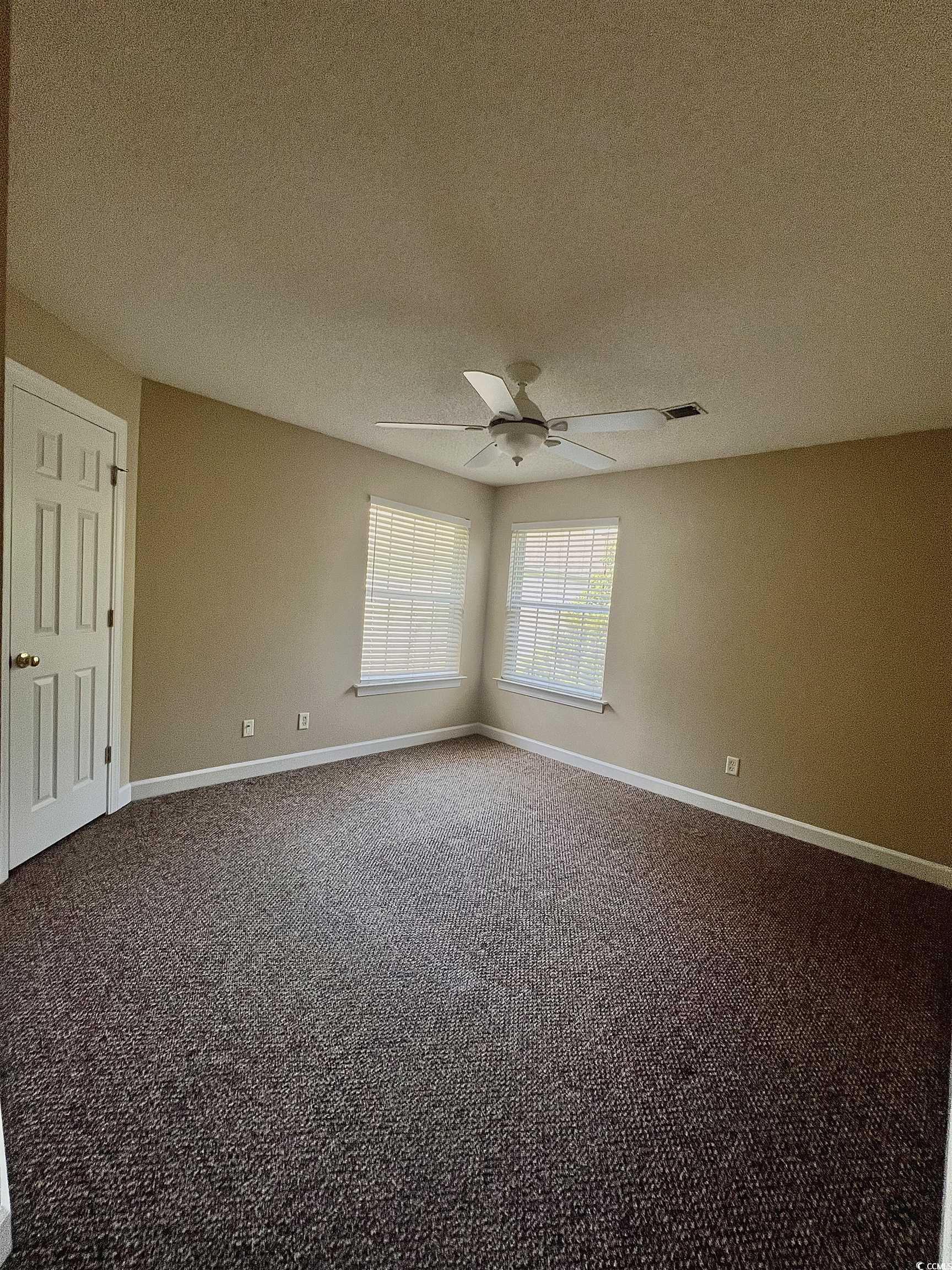 4394 Daphne Lane, Unit F Murrells Inlet, SC 29576 - Photo 23 of 40 Spare room with carpet flooring, a ceiling fan, a textured ceiling, and baseboards