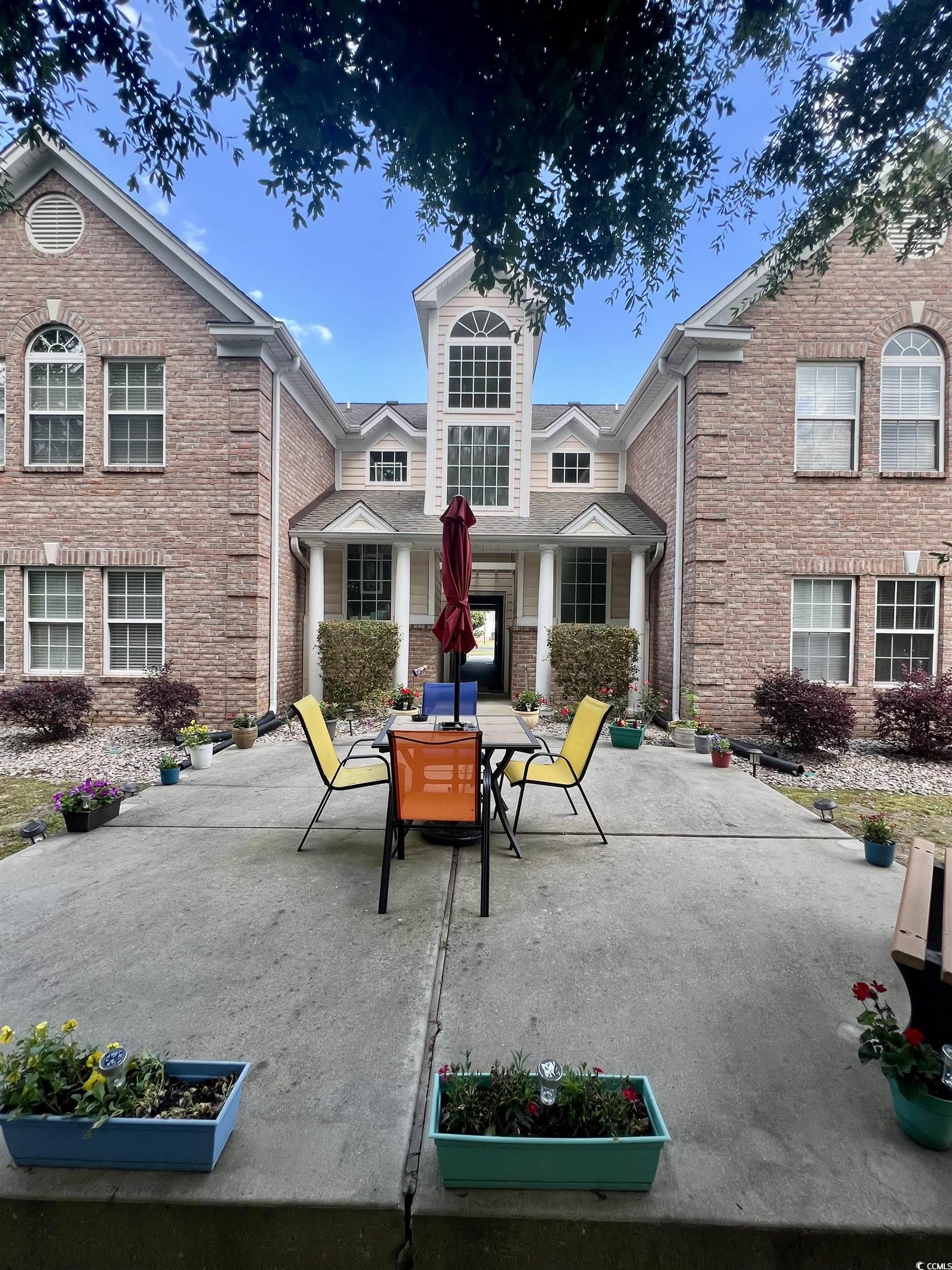4394 Daphne Lane, Unit F Murrells Inlet, SC 29576 - Photo 33 of 40 View of patio with outdoor dining area