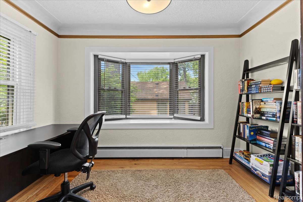 43 Wellesley Drive Pleasant Ridge, MI 48069 - Photo 8 of 52 Bay window with blinds, wood-finish flooring, and crown molding